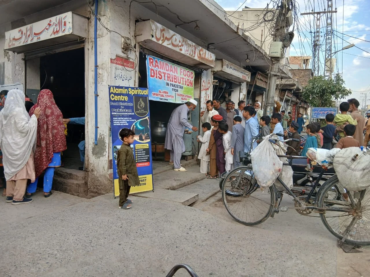 Families gathering outside one of Alamin’s food distribution points